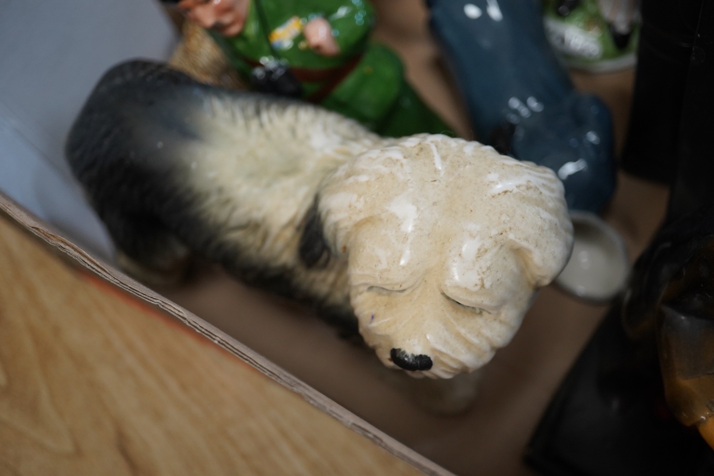 A pair of painted plaster figural bookends, a pottery Highland Cow and other Staffordshire figures etc (7)